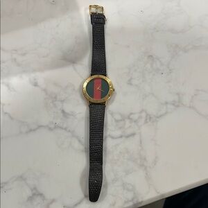 Gold and Black Watch with Red and Green Dial